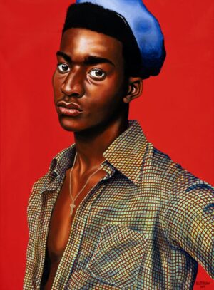 Portrait of a man against a strong red background with a blue beret